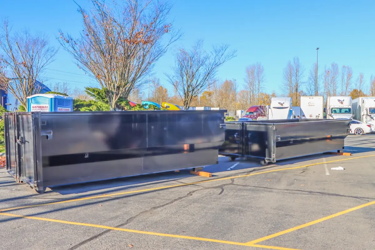 Professional dumpster rental service with roll-off container on residential driveway in Orting